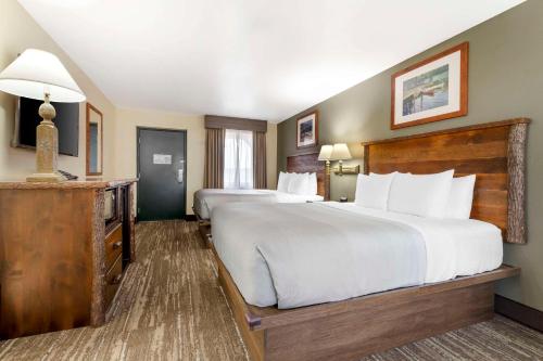 a large hotel room with two beds and a table at Quality Inn Ashland - Lake Superior in Ashland