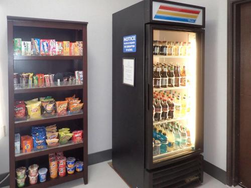 a black refrigerator in a room with food and drinks at Brentwood Suites Nashville, an Ascend Collection Hotel in Brentwood