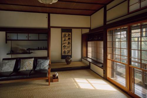 a living room with a couch and a window at 旧雨今雨 in Onomichi