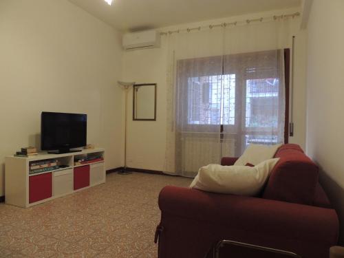 a living room with a couch and a television at La casa di Maro in Lido di Ostia