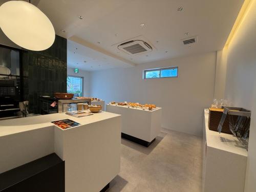 a room with white counters with food on display at Bakery Hotel SHIRAHAMA ベーカリーホテル シラハマ in Shirahama