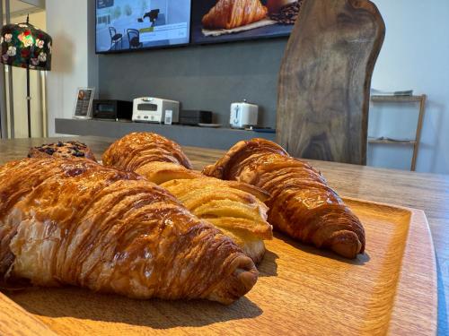 a bunch of croissants on a cutting board on a table at Bakery Hotel SHIRAHAMA ベーカリーホテル シラハマ in Shirahama
