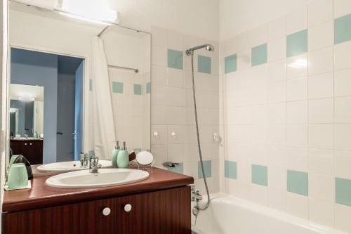 a bathroom with a sink and a shower and a tub at 123 - Charme, piscine et évasion in Pornic