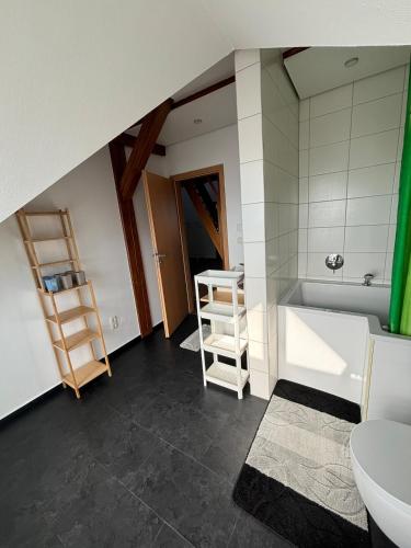 a bathroom with a tub and a toilet and a sink at Wohnung mit Galerie in Prenzlau
