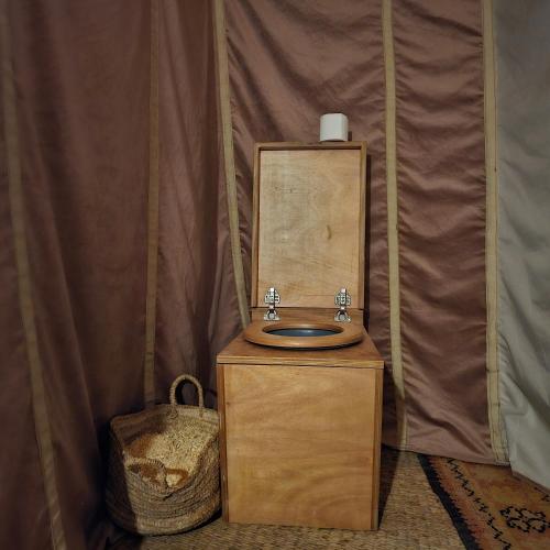 a wooden bathroom with a sink in a tent at Bivouac Joudour Sahara in Mhamid