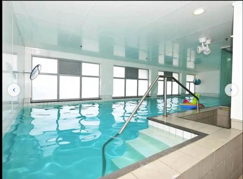 a large swimming pool with a hose in the water at Auckland city central apartment 2 bedrooms apartment Wi-Fi balcony harbor or skytower view near public parking 1204 in Auckland