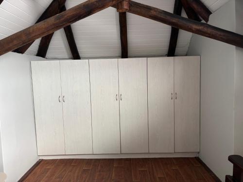 a room with white cabinets in a attic at Aspire on Meier in East London
