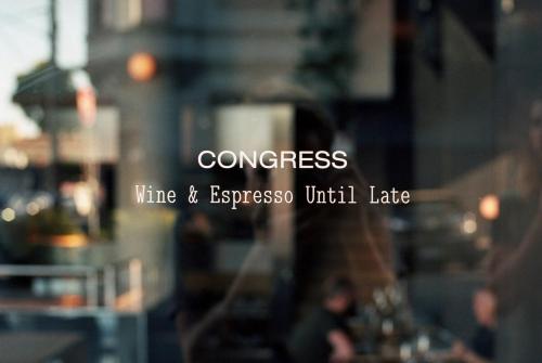 a glass window with the words congress time andyssopus until late at Penthouse Apartment Collingwood in Melbourne