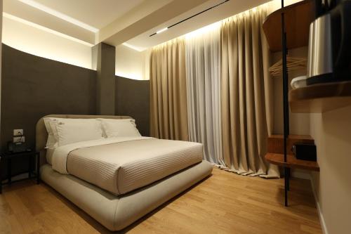 a bedroom with a white bed and curtains at Beratinus1 in Berat