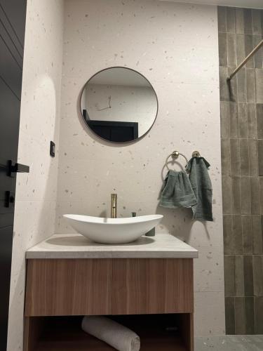 a bathroom with a white sink and a mirror at Anika - Mountain Home in Divčibare