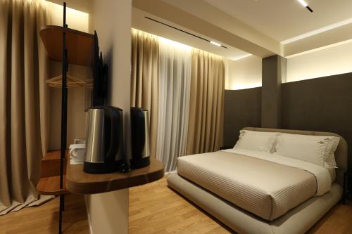 a bedroom with a bed and a flat screen tv at Beratinus1 in Berat