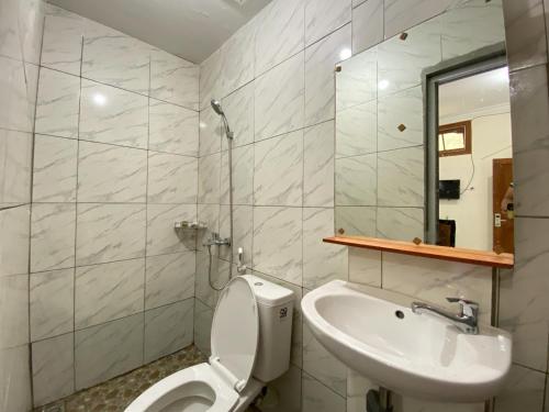 a bathroom with a toilet and a sink at RedDoorz near RSUD Tidar Magelang in Magelang