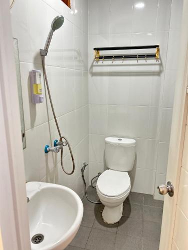 a bathroom with a toilet and a sink at Wisma Grace in Ambon