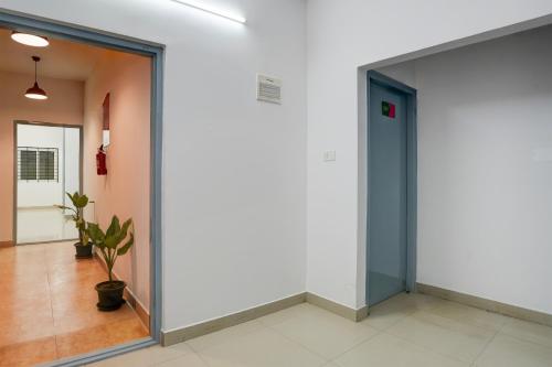 a hallway with a glass door in a building at Super Hotel O Whitefield in Bengaluru