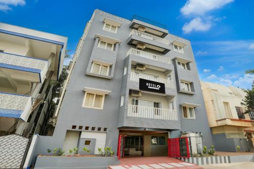a tall grey building with a sign on it at Super Hotel O Whitefield in Bengaluru