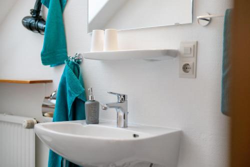 a bathroom with a white sink and a mirror at Haus Bührer in Freiamt