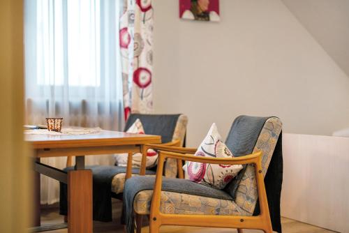 a dining room with two chairs and a table at Haus Bührer in Freiamt