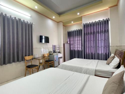 Postel nebo postele na pokoji v ubytování Huy Hoàng Motel - Cần Thơ