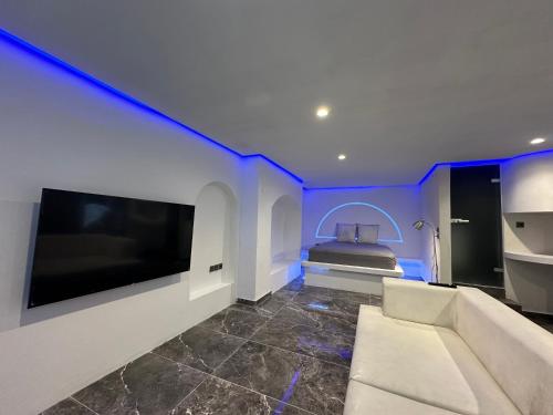 a living room with a couch and a bed at Cycladic Suite in Thessaloniki
