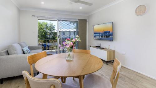a living room with a table and a couch at 'deja Blue' in Bongaree