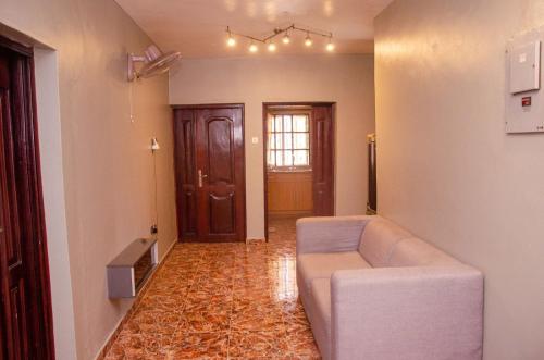 a living room with a couch and a door at Soolar Apartment in Ikorodu in Ikorodu