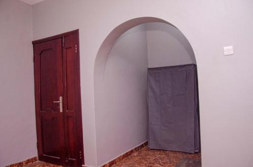 an archway in a room with a door at Soolar Apartment in Ikorodu in Ikorodu