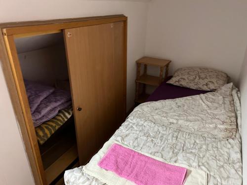 a small bedroom with a bed and a closet at Slobo Velickovic in Prokuplje