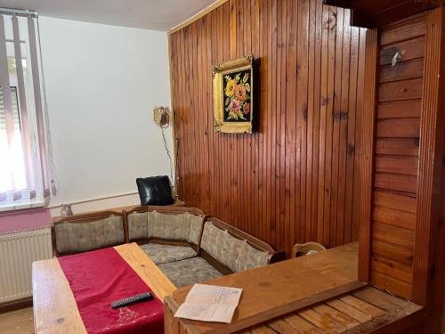a room with a table and a wooden wall at Slobo Velickovic in Prokuplje
