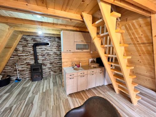 a kitchen with a staircase in a log cabin at Villa Alpina in Boge