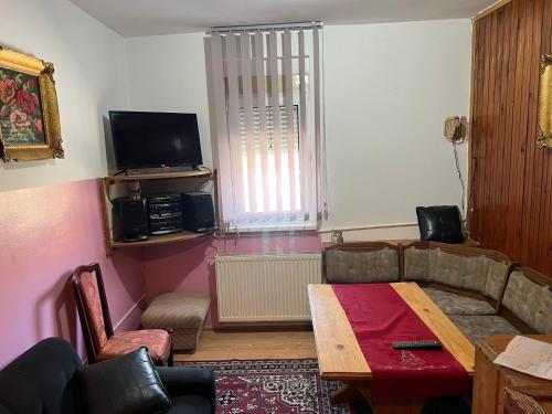 a living room with a couch and a table at Slobo Velickovic in Prokuplje