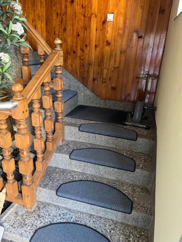a set of stairs with a wooden stair case at Slobo Velickovic in Prokuplje