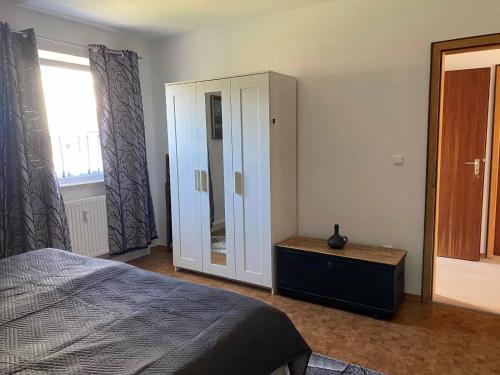 a bedroom with a bed and a dresser and a window at Ferienwohnung Familie Augustin in Furth im Wald
