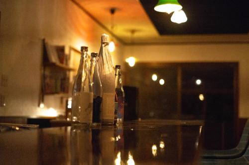 a group of bottles sitting on a counter in a room at ゲストハウス桜月荘 in Kagoshima