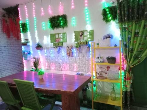 a table in a room with lights on a wall at GS Homestay Banyuwangi in Banyuwangi