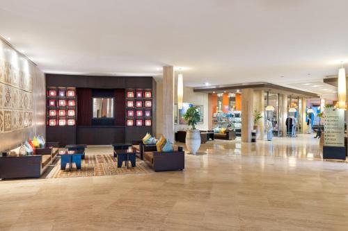 a lobby of a hotel with couches and tables at Atlas Essaouira Riad Resort in Essaouira