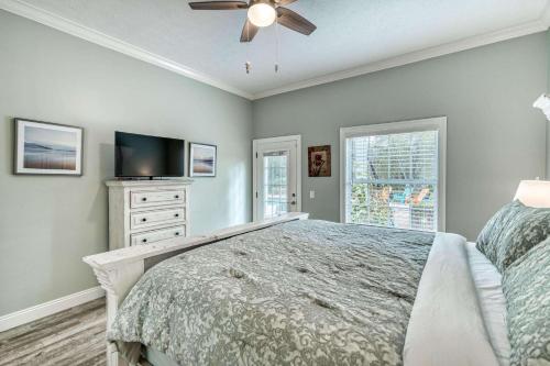 a bedroom with a bed and a ceiling fan at Sandy's Seacrest in Inlet Beach