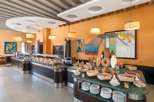 a buffet line in a restaurant with a lot of food at Atlas Essaouira Riad Resort in Essaouira