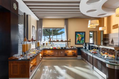a large kitchen with a buffet line in a restaurant at Atlas Essaouira Riad Resort in Essaouira