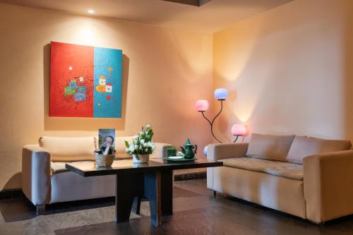 a living room with a couch and a table at Atlas Essaouira Riad Resort in Essaouira