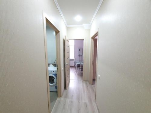a hallway of a room with a washing machine at Apartment in The Heart of the Capital in Chişinău