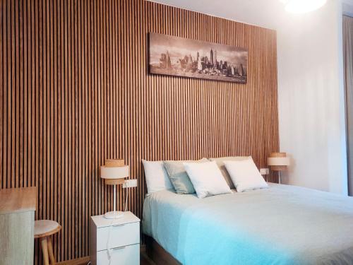 a bedroom with a bed and a striped wall at El Escondite de Biescas in Biescas