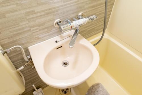 a bathroom with a white toilet and a sink at 301奈良難波に便利な静かで快適マンション in Higashi-osaka
