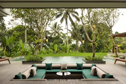 a living room with a couch and a pool at Inara Alas Harum in Ubud