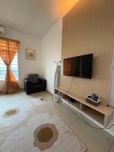 a living room with a flat screen tv on a wall at Private Studio Viana Court Service Apartment 3 with private parking in Kota Bharu