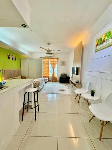 a kitchen and living room with white appliances and chairs at Private Studio Viana Court Service Apartment 3 with private parking in Kota Bharu