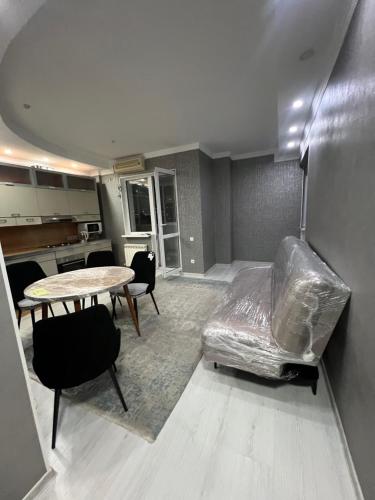 a living room with a couch and a table at Banur Ип in Almaty