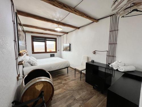 a bedroom with a bed and a desk and a mirror at B&B Didova in Gavoi