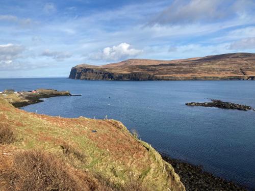 a large body of water with mountains in the background at Skye Falls Chalet in Milovaig