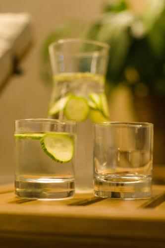 two glasses of water with lime on a table at First Hotel Witt in Kalmar