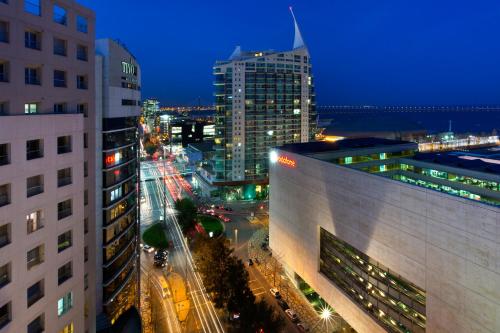 a view of a city at night with buildings at Oriente 25 Housing by APT IIN in Lisbon